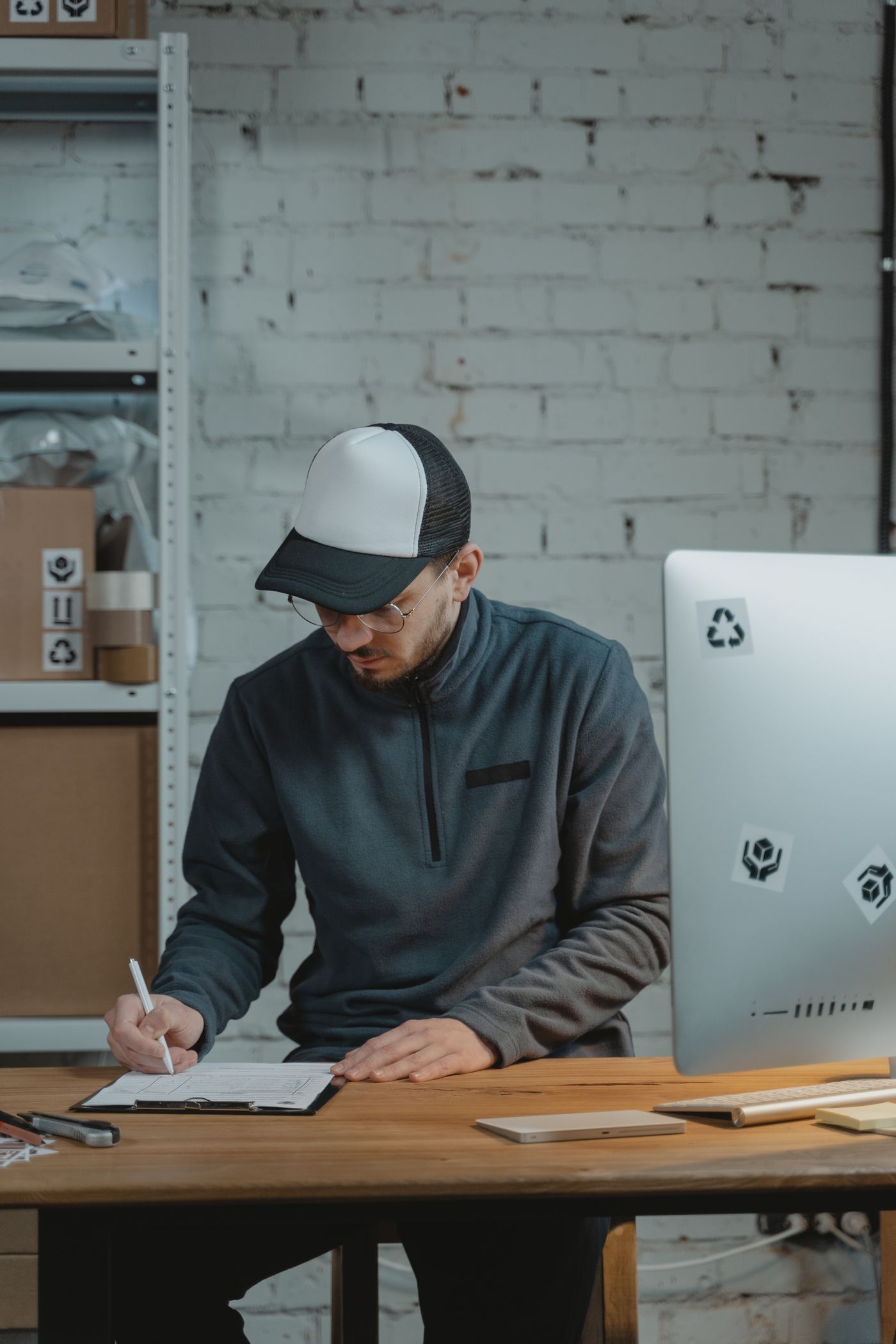 Delivery specialist reviewing shipment information at an organized desk
