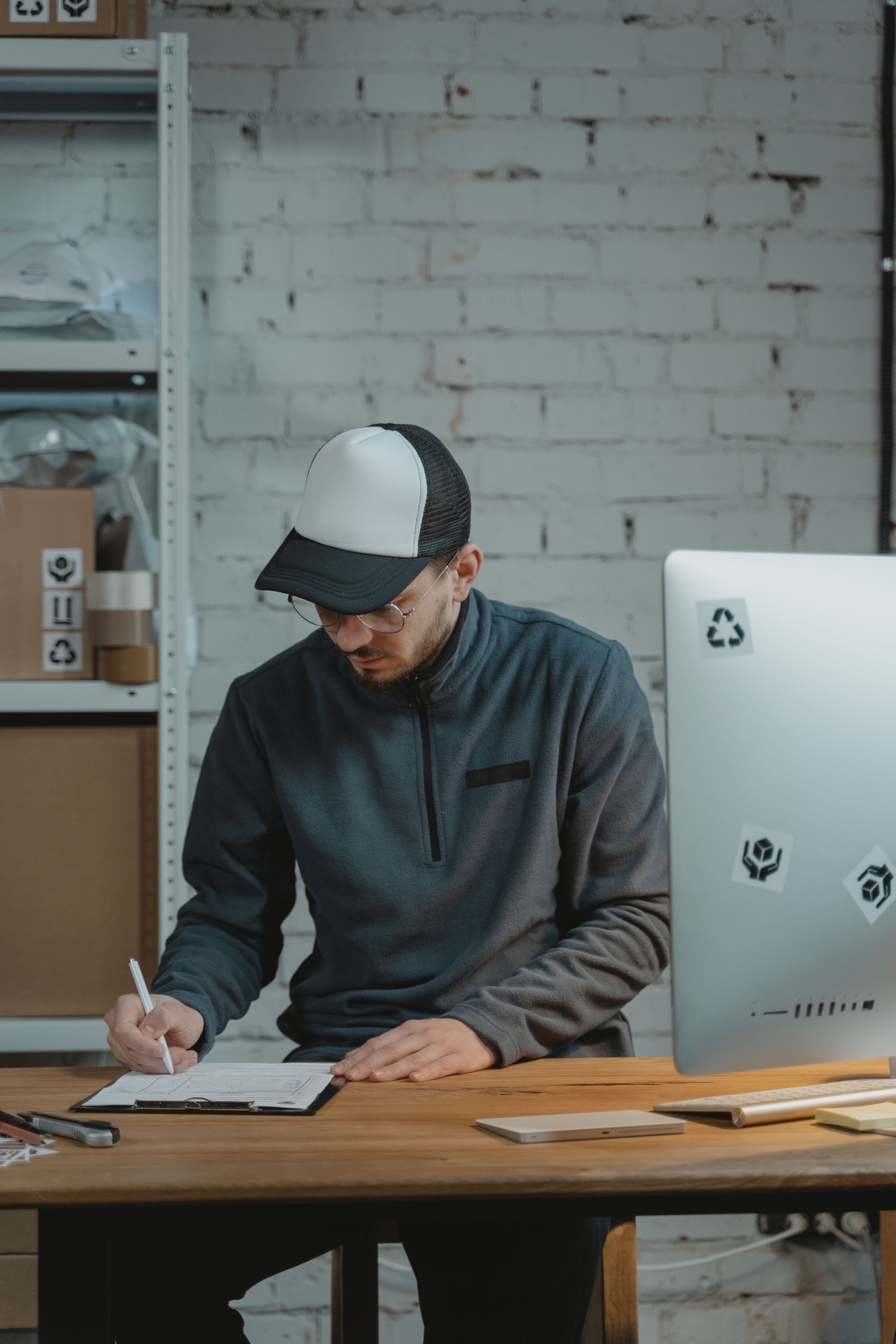 Logistics professional completing paperwork in a delivery service center