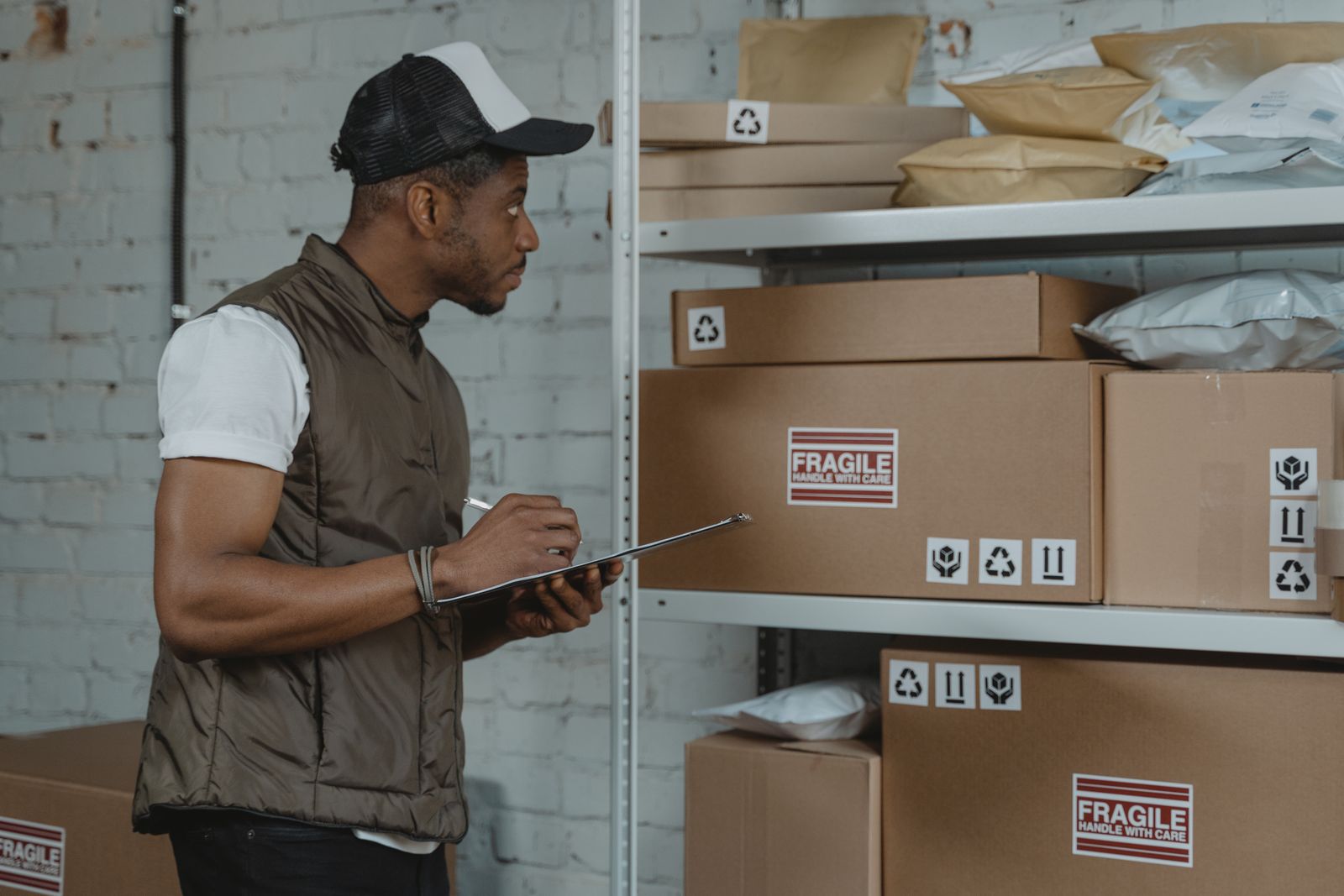 Packer preparing bulk parcels and cartons for sourcing shipment