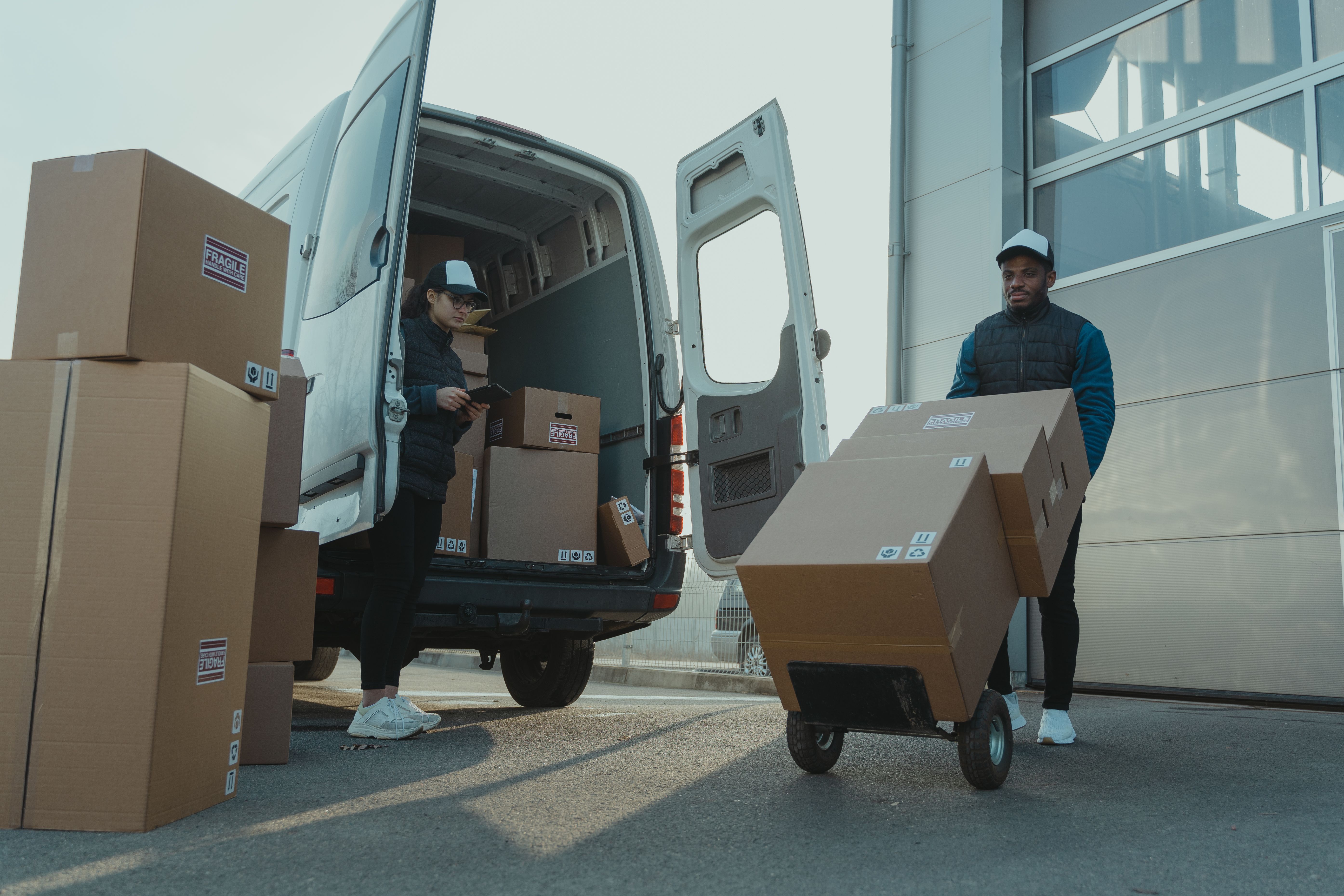 Packed parcels, export materials, and sourcing samples arranged on a work surface.