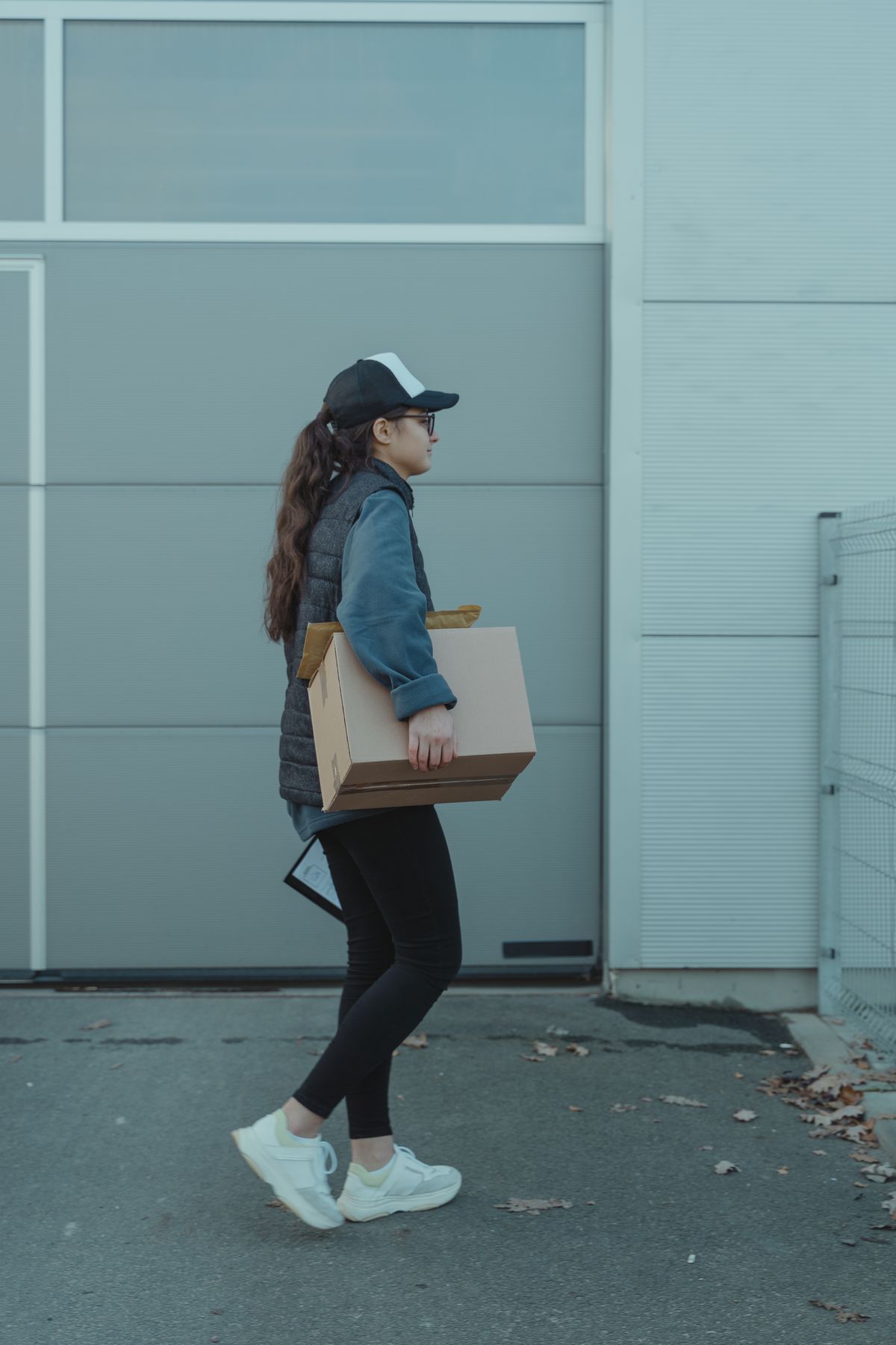 Courier carrying a shipping package for delivery