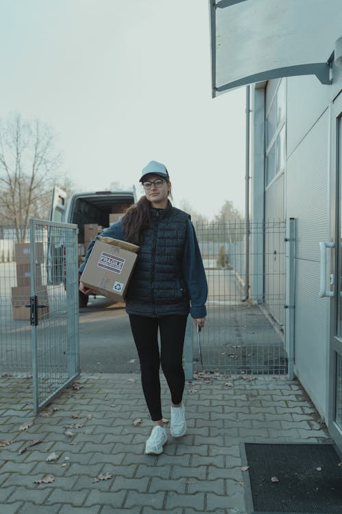 Female Courier carrying a Box