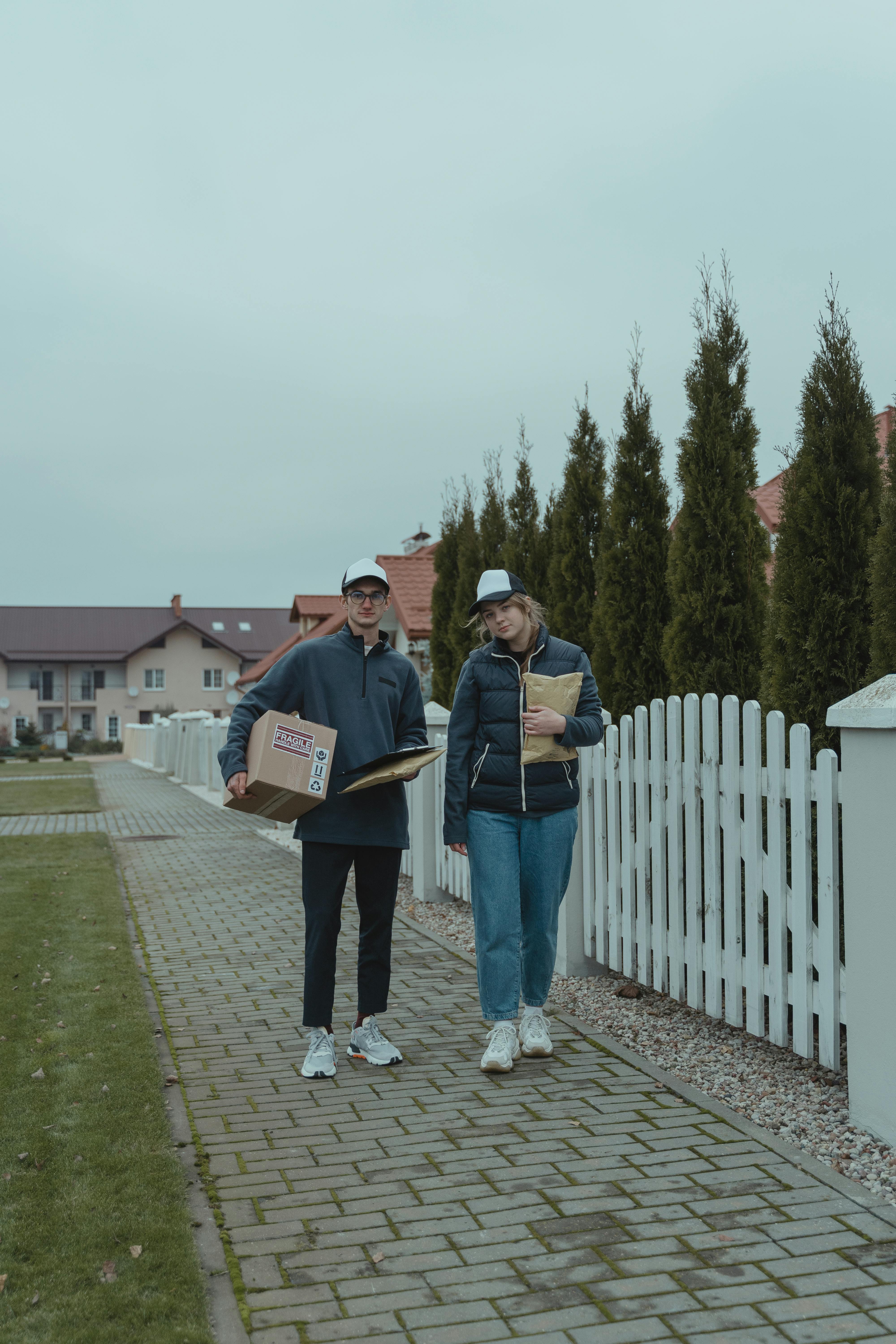 two delivery people standing beside each other