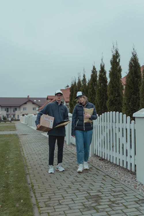 Two Delivery People standing beside each other