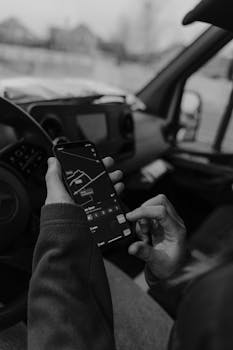Monochrome image of using smartphone GPS for navigation inside a car.