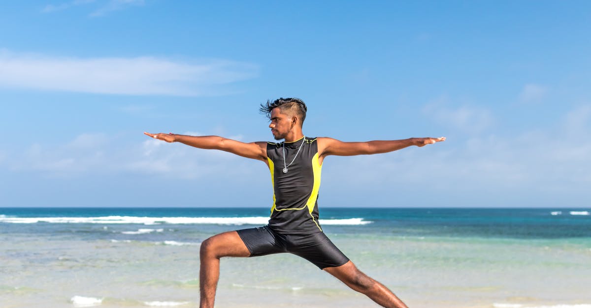 Man in Sleeveless Wet Suit Doing Some Aerobics at the Beach