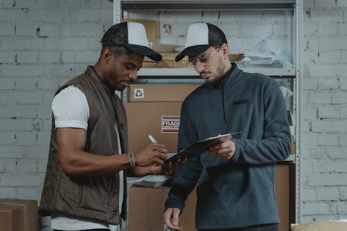 Man signinig on a Clipboard 