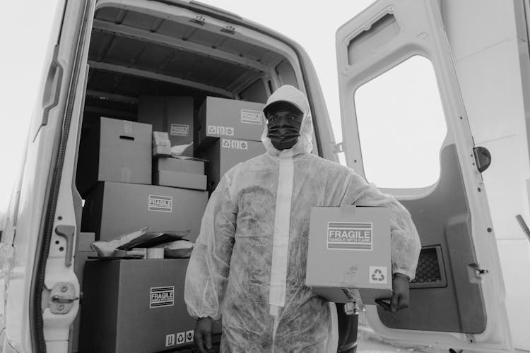 Delivery Man In PPE Delivering Packages