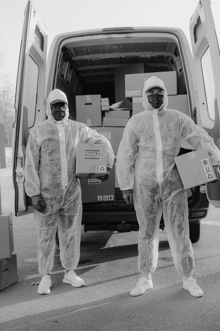 Delivery Men In PPE Delivering Packages