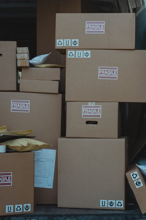 Free Close-up Photo of Stacked Carton Boxes Stock Photo