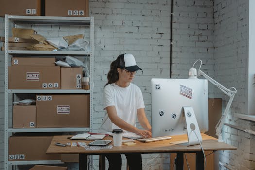 Focused female working on a computer in an organized industrial-style office space.