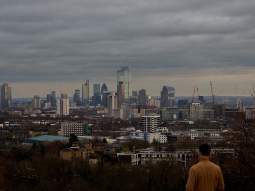 Free Dramatic view of a modern city's skyline under a gloomy sky with tall skyscrapers. Stock Photo
