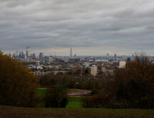Free A view of the London skyline from an elevated angle, showcasing iconic buildings under a cloudy sky. Stock Photo