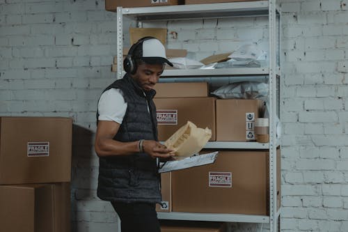 Male Employee looking at a Parcel 