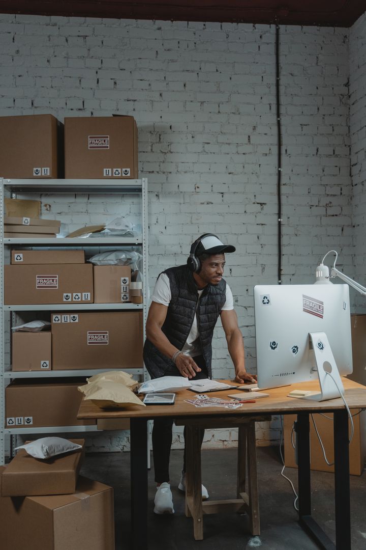 A man packing an order for shipping in a warehouse