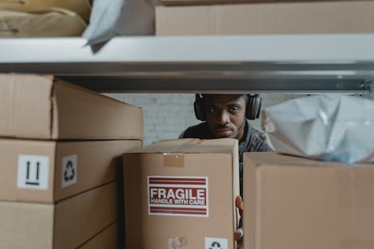 shipping package inspection - Focused warehouse worker organizes and inspects fragile packages.