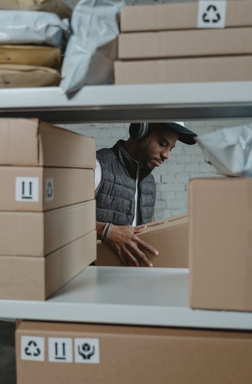 Male Employee through a Shelf