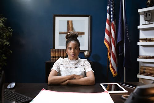 Professional Woman sitting beside a Wooden Table