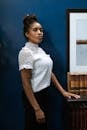 Professional Woman standing beside a Wooden Table