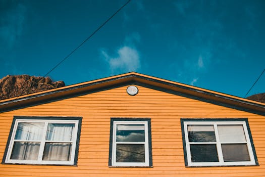 Bright wooden house facade under clear skies, capturing a serene outdoor setting.