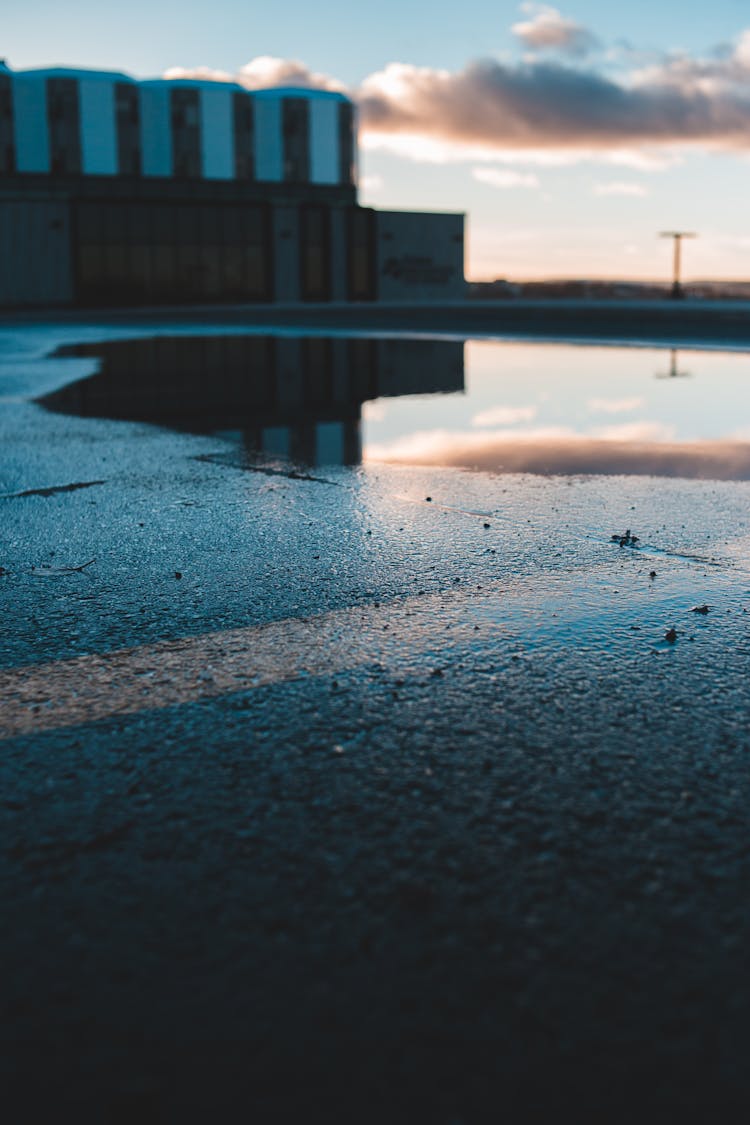 A Puddle Water On Concrete Pavement