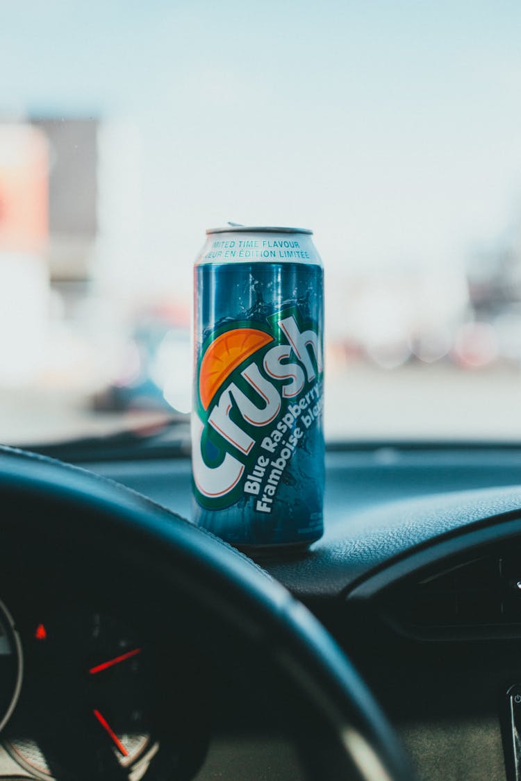 Can Of Soft Drink On Car Dashboard