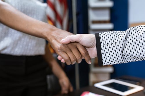 Free Two People Shaking their Hands Stock Photo