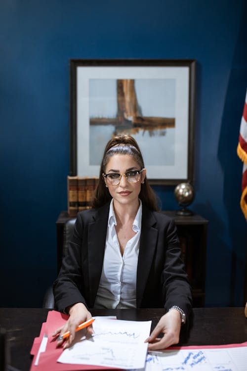 Woman in Black Blazer Sitting on Chair