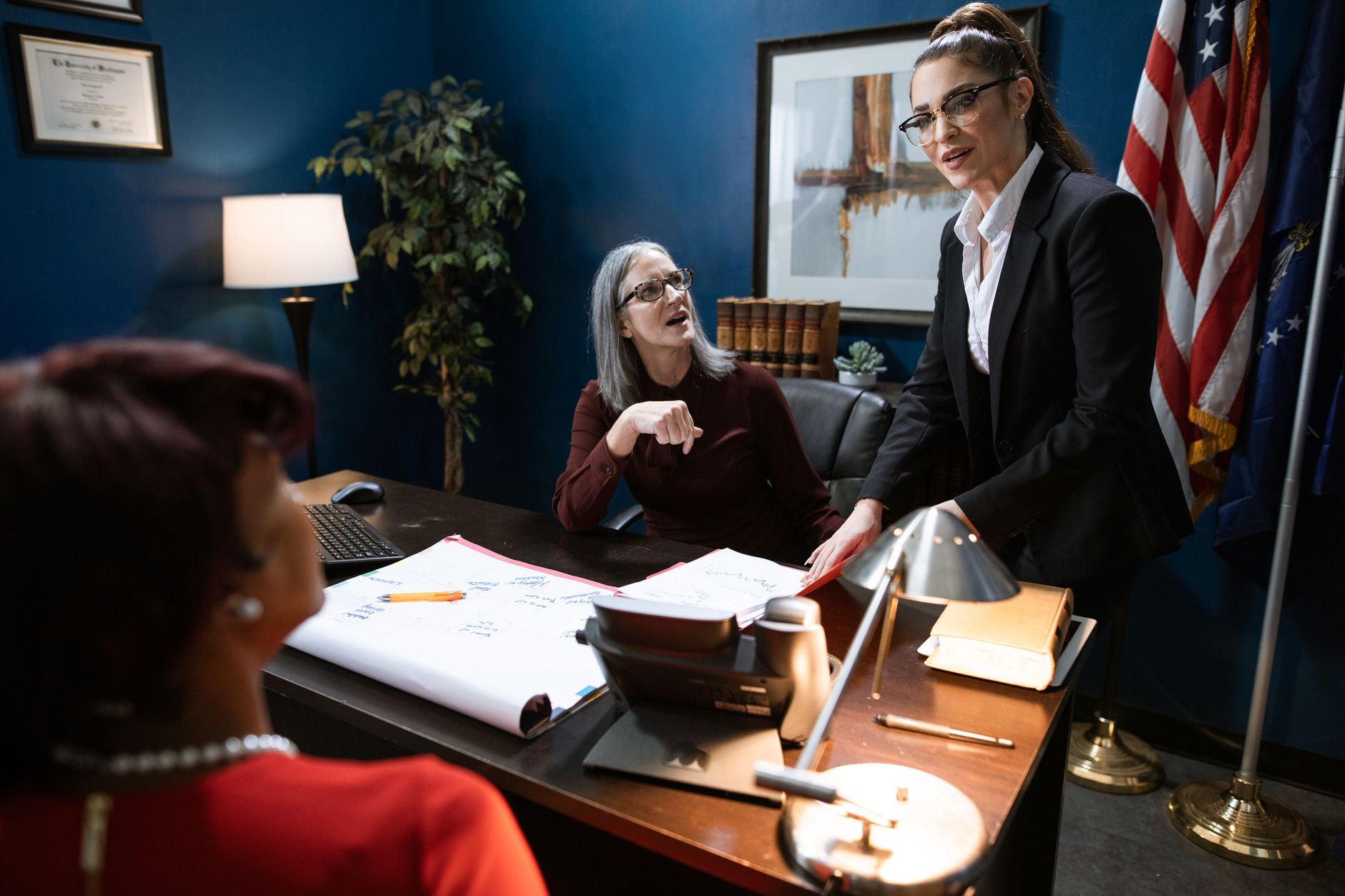 A sophisticated high-end legal office setting with a global map and elegant desk accessories.