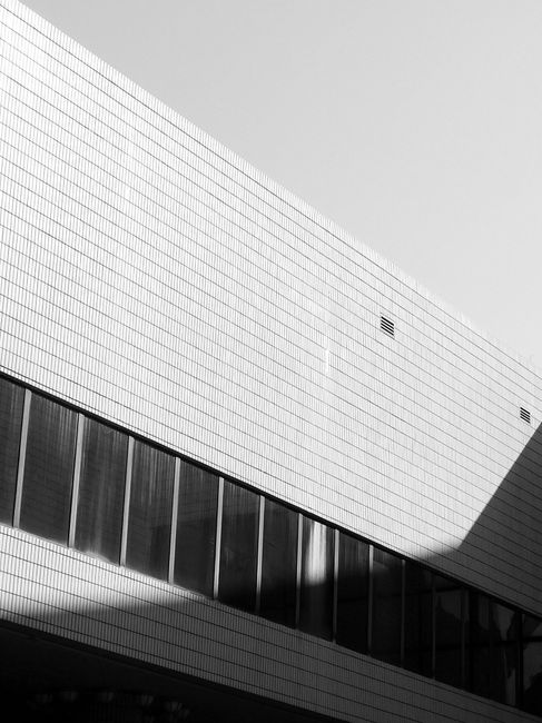Black and white of exterior design of contemporary building with glass windows and geometric shapes