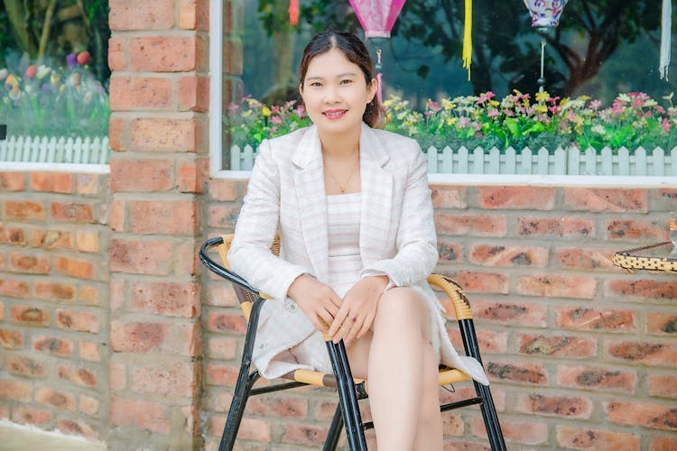 Elegant Woman In Formal Wear Sitting On A Chair