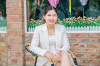Elegant Woman in Formal Wear sitting on a Chair
