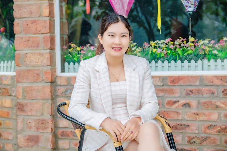 Elegant Woman In Formal Wear Sitting On A Chair