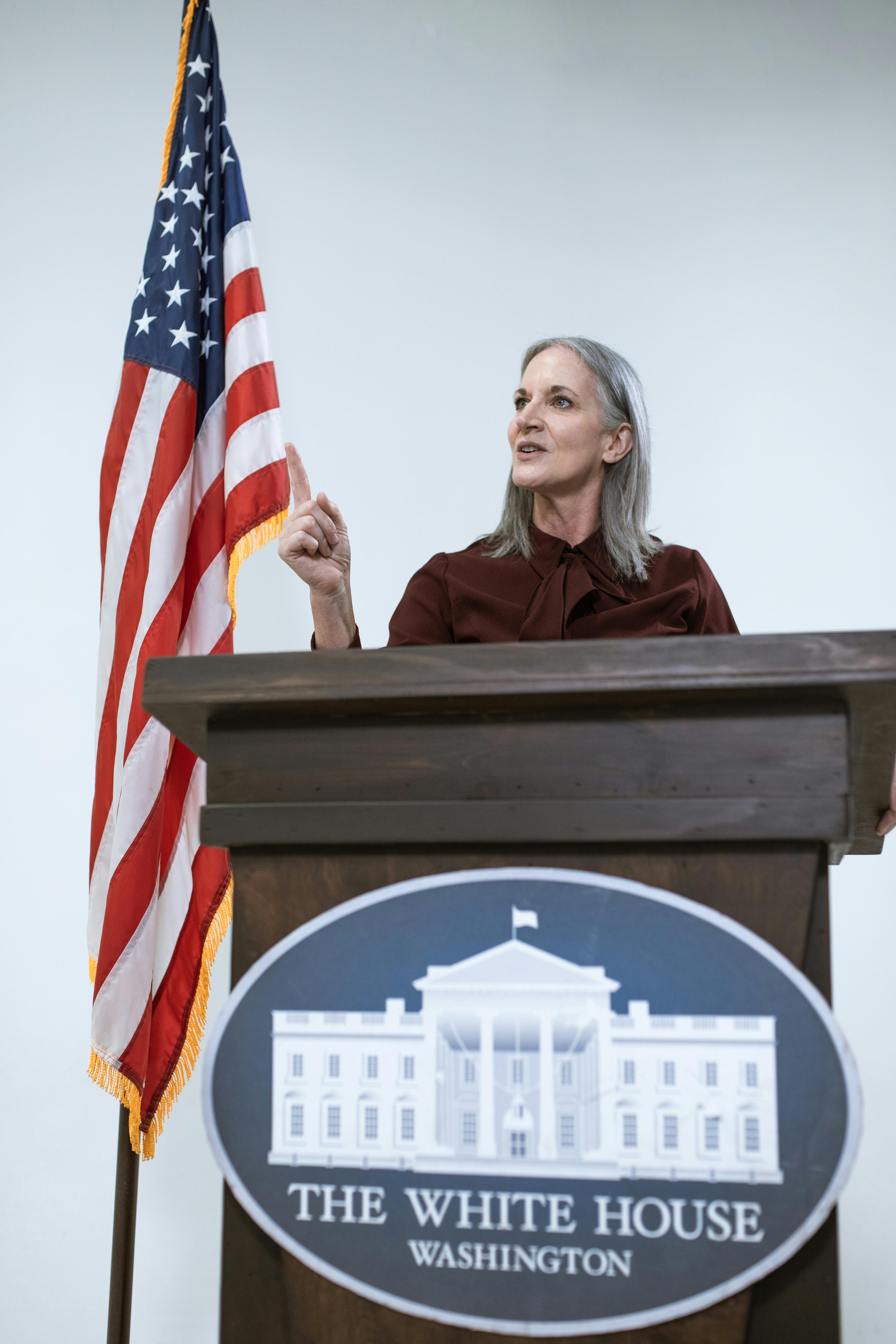 woman behind a brown podium