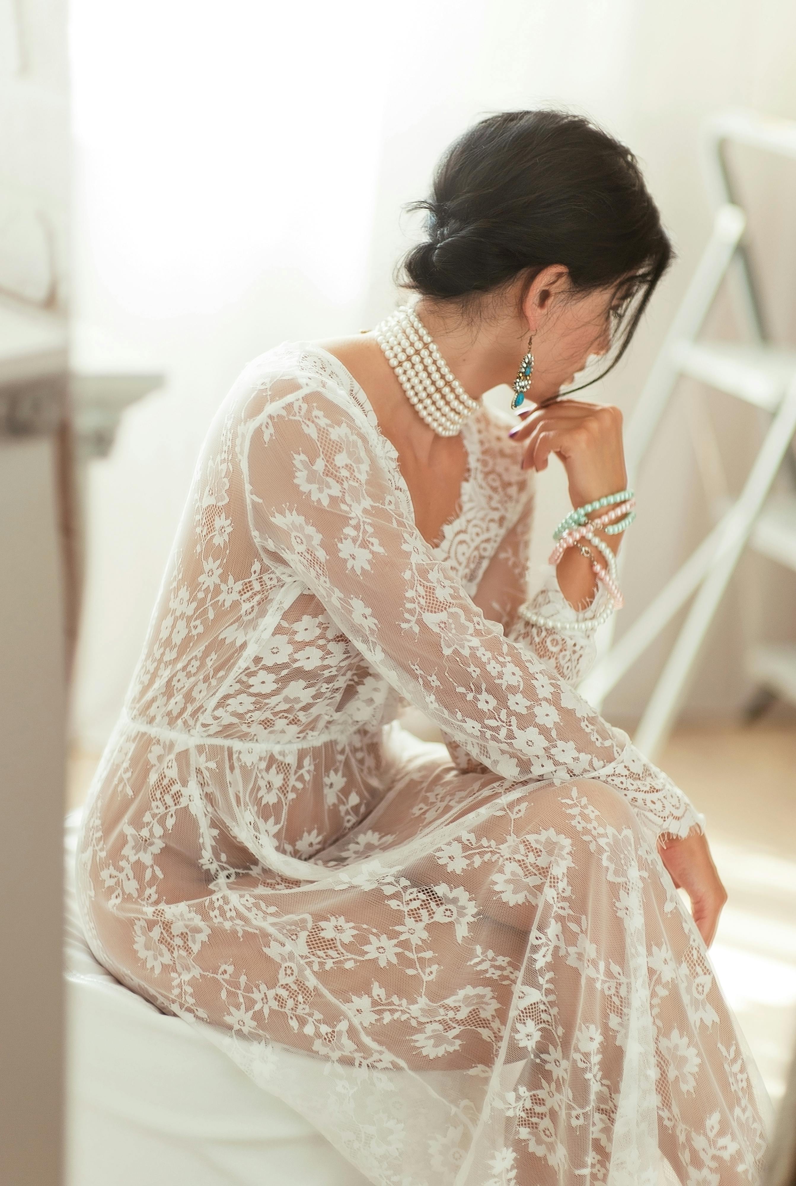 woman in white lace long sleeve dress