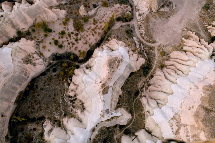 Aerial View Of White And Brown Rocks And Grass Patches