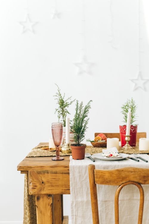 Free Chic table arrangement with plants, candles, and glassware on a wooden table. Stock Photo