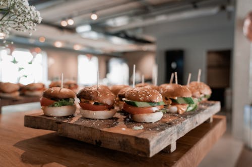 Close-Up Shot of Delicious Hamburgers on Wooden Chopping Board