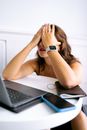 Woman in Black and White Watch Sitting on Chair in Front of Laptop Computer