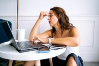Woman in White Tank Top Using Macbook Air