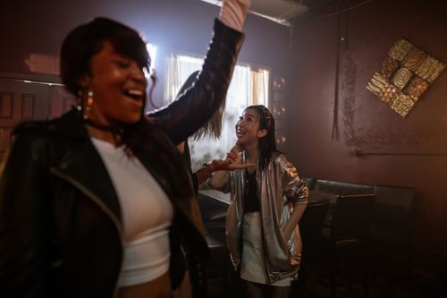 Free Lively nightlife scene with women dancing and enjoying a night out at a club. Stock Photo