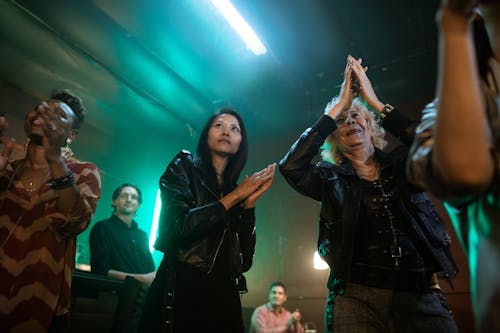 Women in Black Leather Jackets Clapping Hands