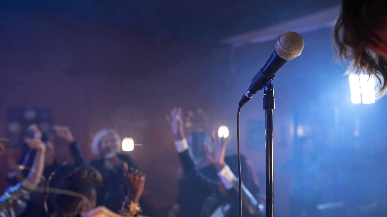 Representative photograph of a nightclub microphone and audience; not Chris Brown, the London court or the 2023 incident
