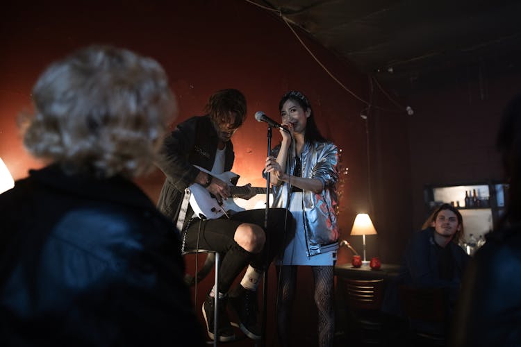 Audience Looking At A Man And A Woman On Stage