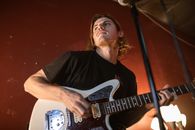 Man in Black Crew Neck T-shirt Playing White Electric Guitar