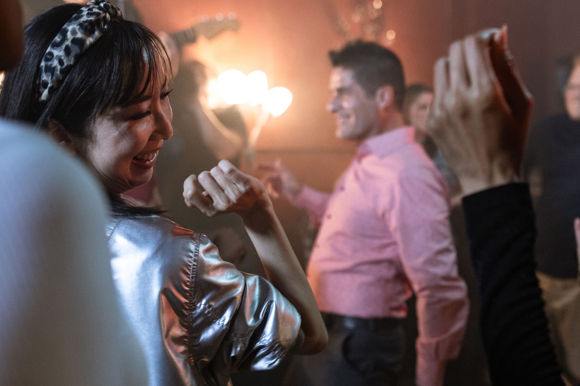 Energetic group of adults dancing and having fun in a vibrant nightclub atmosphere.