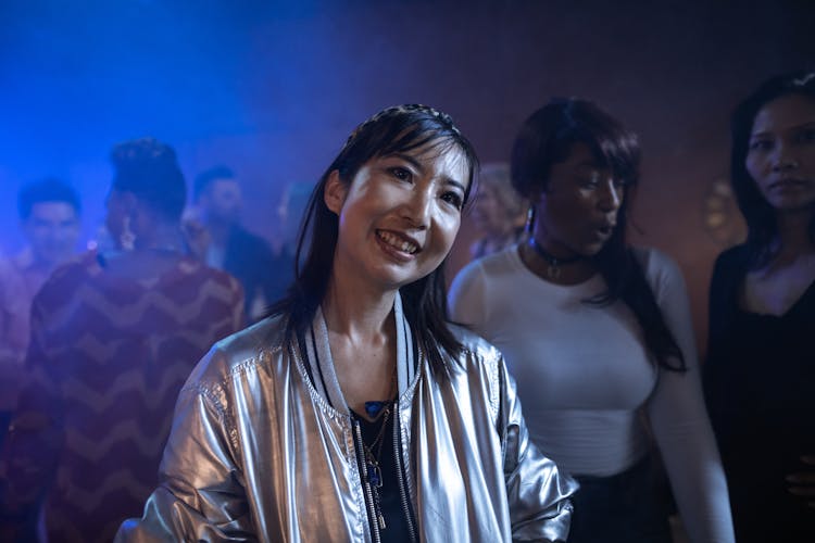 Smiling Woman In Silver Bomber Jacket