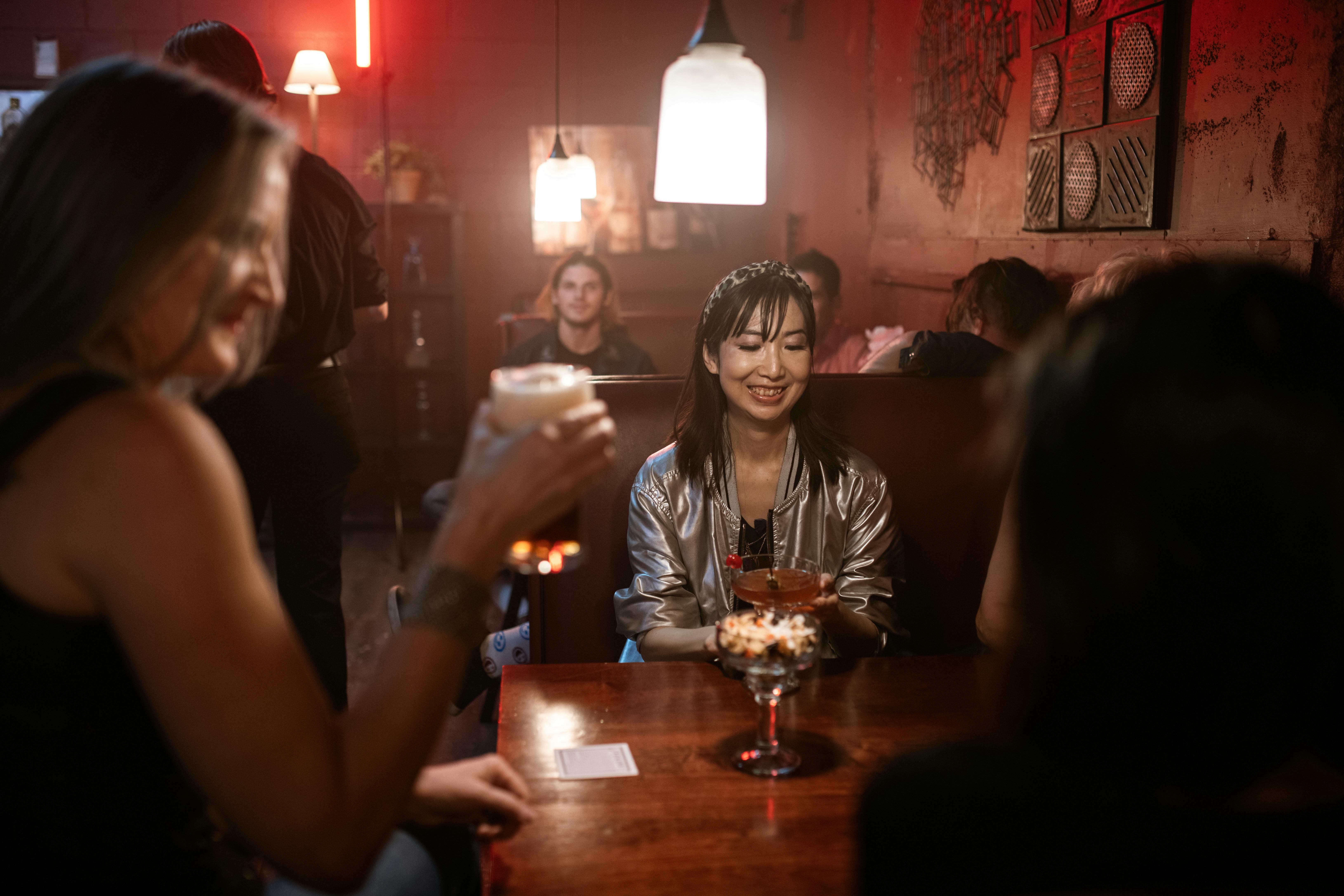 woman in black shirt sitting beside woman in black shirt