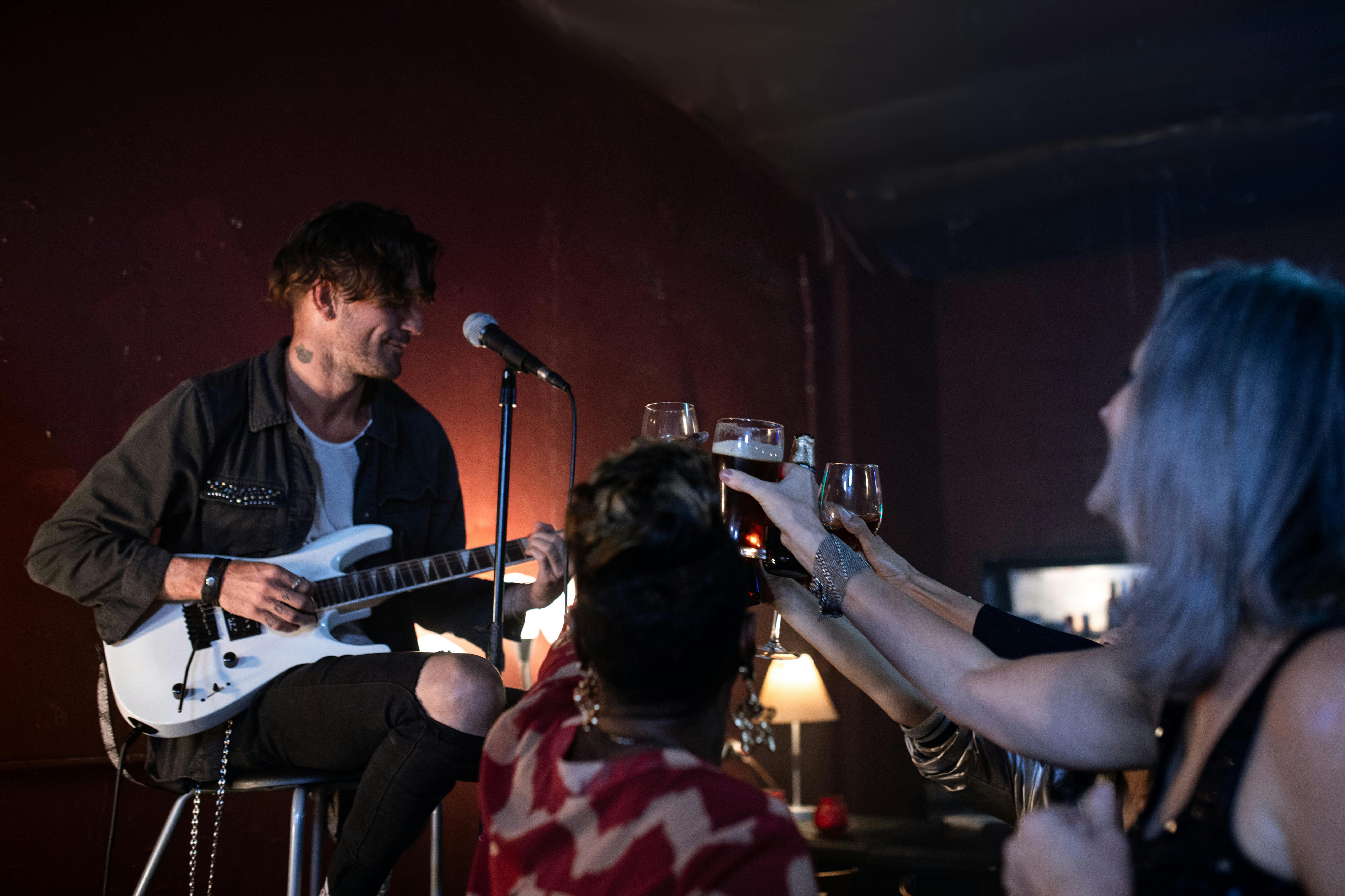 man in black shirt playing guitar