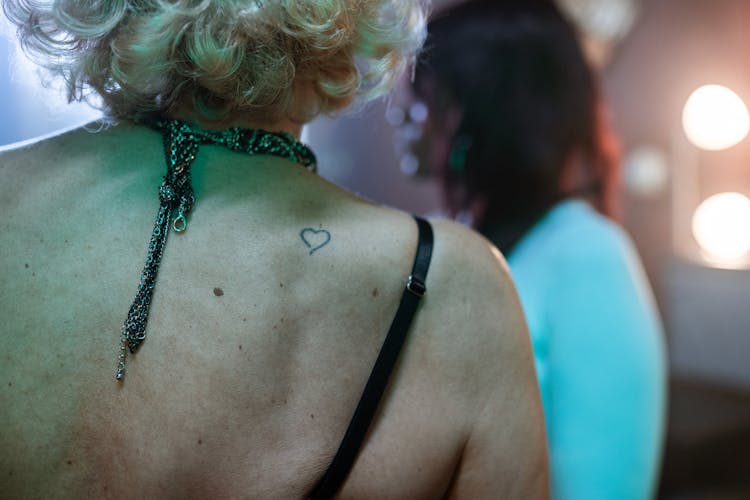 Heart Shape Tattoo On A Person's Back